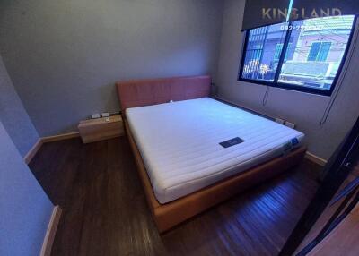 Bedroom with a large bed and wooden flooring