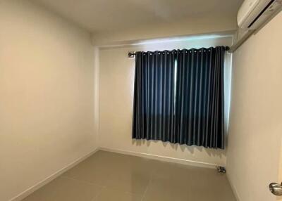 Empty bedroom with tiled floor and window with curtains