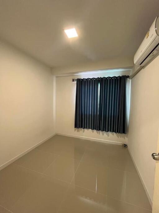 Empty bedroom with tiled floor and window with curtains