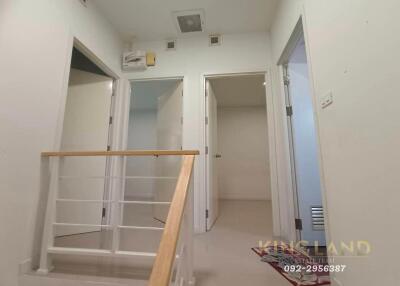 Interior hallway with view of adjoining rooms and staircase