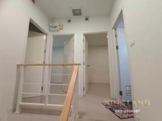 Interior hallway with view of adjoining rooms and staircase