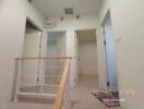 Interior hallway with view of adjoining rooms and staircase