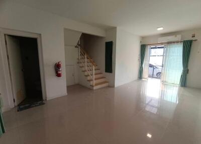 Spacious living room with staircase and large glass doors