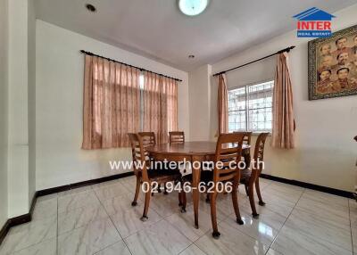 Dining room with a wooden table and six chairs, large windows with curtains, white tiled floor, and a decorative wall painting