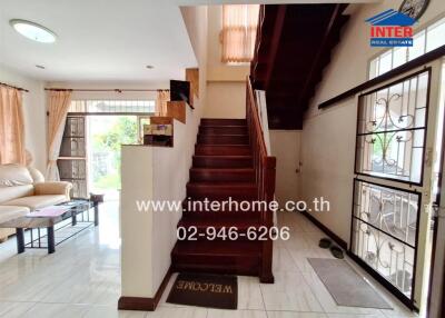 Cozy main living area with staircase and natural light