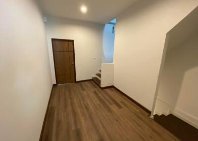 Hallway with wooden floor and staircase