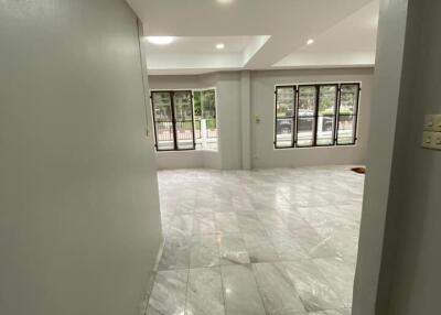 Spacious main living area with large windows and marble floors