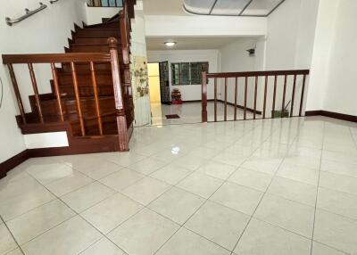 Spacious entrance with wooden staircase