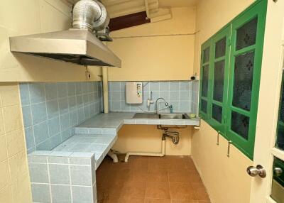 Simple kitchen with tiled countertops and a sink