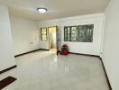 Spacious living room with tiled floor and window