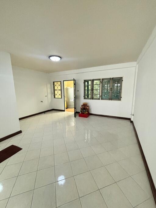 Spacious living room with tiled floor and window