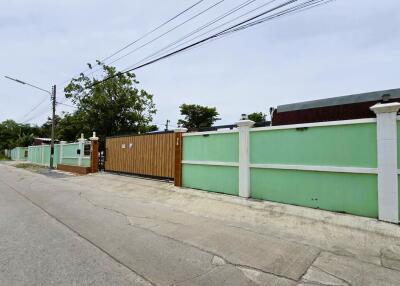 Front view of property entrance with driveway and fencing