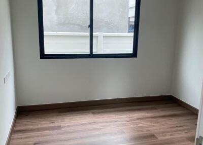 Unfurnished bedroom with wooden floor and window