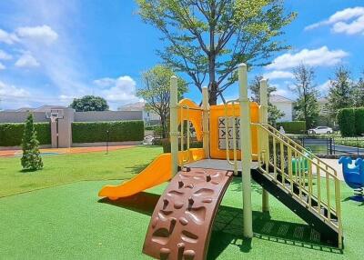 Outdoor playground area with slide and climbing structure