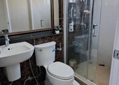 Modern bathroom with glass shower enclosure and sleek fixtures