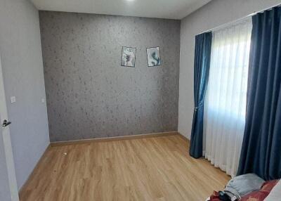 Spacious Bedroom with Blue Curtains and Wall Art