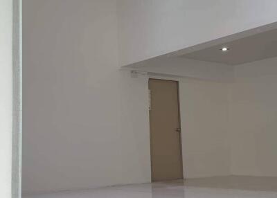 Empty room with high ceiling and tiled floor