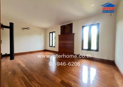 Spacious living room with hardwood floors and large windows