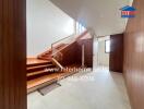 Staircase area with wooden steps and glass railing