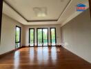 Spacious living room with wooden floor and large windows