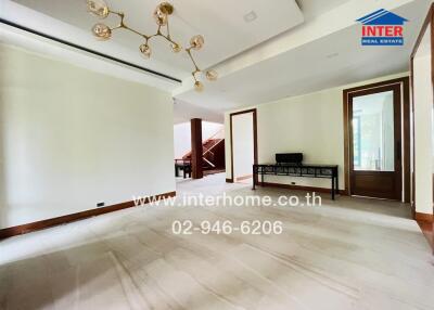 Spacious main living area with modern chandelier and large windows