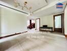 Spacious main living area with modern chandelier and large windows