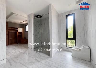 Bathroom with glass-enclosed shower and modern toilet