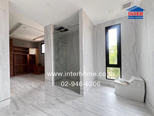 Bathroom with glass-enclosed shower and modern toilet