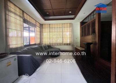 Spacious and cozy living room with large windows and ample seating