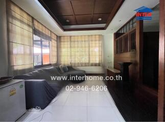 Spacious and cozy living room with large windows and ample seating