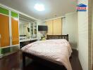 Spacious bedroom with large bed, television, and wardrobe