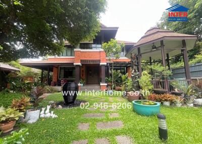 Front view of a two-story house with a landscaped garden