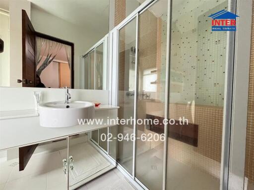 Modern bathroom with glass shower enclosure and vanity mirror