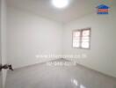 Empty bedroom with a window and a light fixture