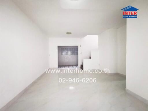 Empty Living Area with Staircase and Tile Flooring