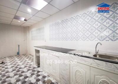 Clean kitchen space with a tiled backsplash and flooring