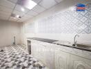 Clean kitchen space with a tiled backsplash and flooring