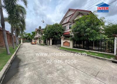 Street view of residential houses with trees and parked cars