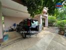 Car parked in a driveway beside a house with a garden