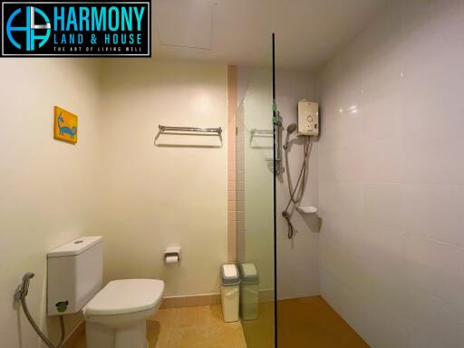 Bathroom with toilet, shower, and water heater