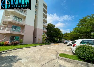 Exterior view of the apartment building with nearby parking area