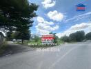 Vacant lot with road and real estate sign