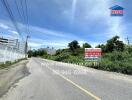 Road leading to the property with signage displaying contact information