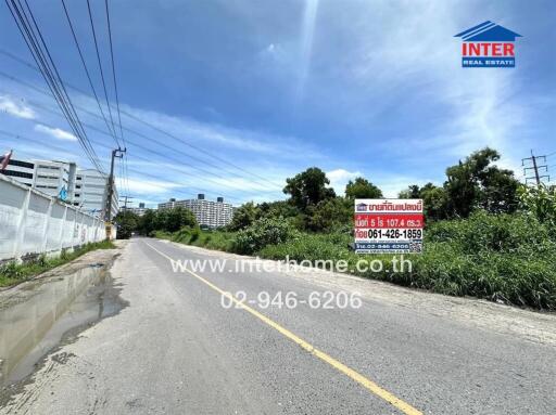 Road leading to the property with signage displaying contact information