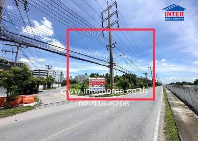 Street view with power lines and real estate sign