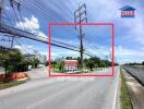 Street view with power lines and real estate sign