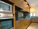 Modern kitchen with wooden cabinets and built-in appliances