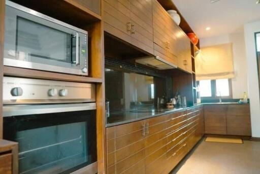 Modern kitchen with wooden cabinets and built-in appliances