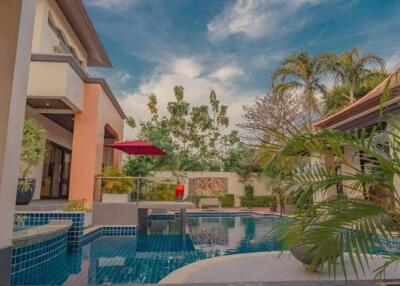 outdoor pool area with view of house