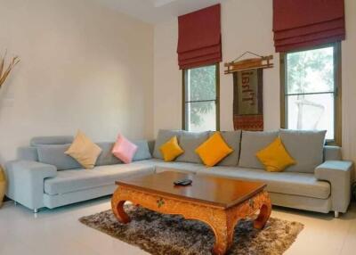 Cozy living room with grey couches and colorful throw pillows